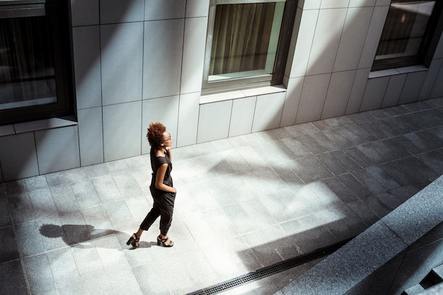 Foto gratuita joven hermosa mujer caminando por la ciudad