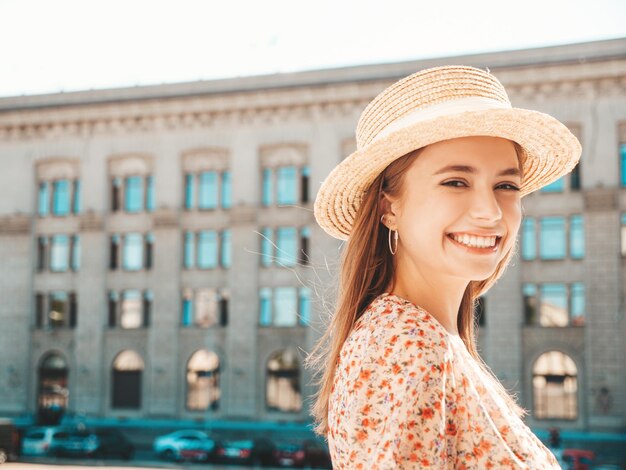 Joven hermosa mujer hipster sonriente en vestido de verano de moda Mujer sexy despreocupada posando en el fondo de la calle con sombrero al atardecer Modelo positivo riendo al aire libre Alegre y feliz