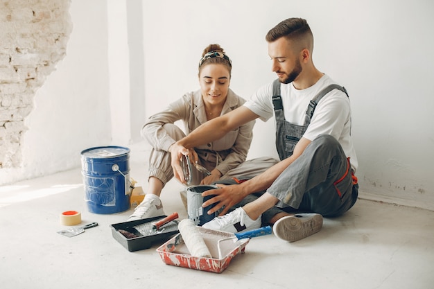 La joven y linda pareja repara la habitación