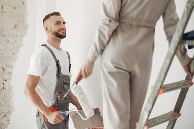 La joven y linda pareja repara la habitación