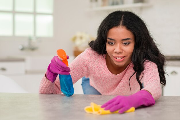 Joven mamá limpiando la casa