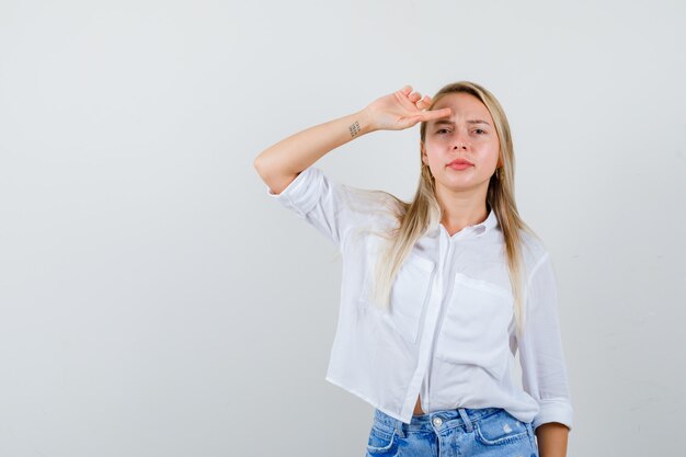 Joven mujer rubia con una camisa blanca