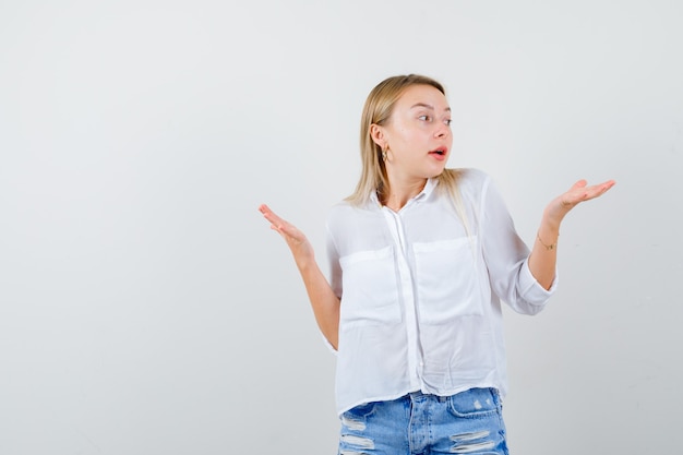 Joven mujer rubia con una camisa blanca