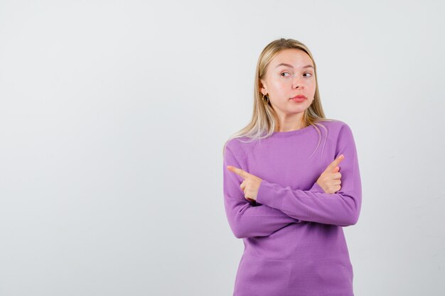 Joven mujer rubia con un suéter morado