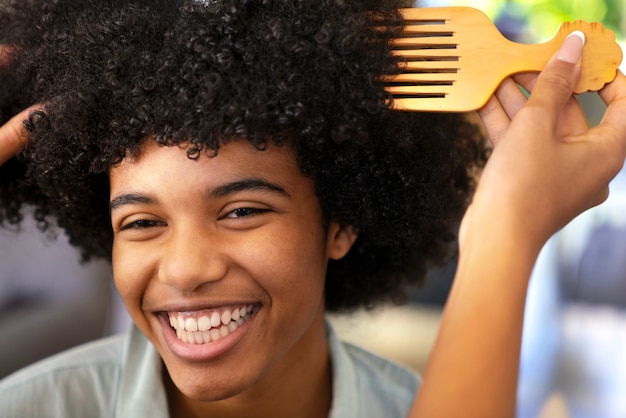 Foto gratuita joven negro cuidando el cabello afro