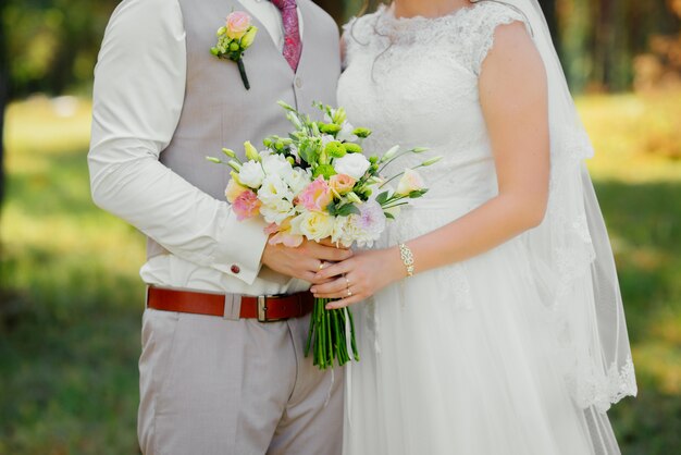 Joven pareja de enamorados, novio y novia en vestido de novia en la naturaleza. Boda.