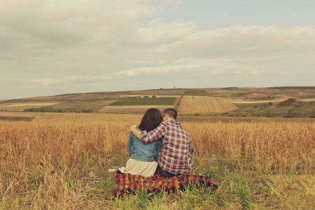 Joven pareja moderna con estilo al aire libre. Joven pareja romántica en el amor al aire libre en el campo