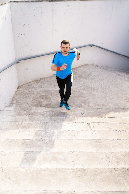 Foto gratuita joven practicando entrenamiento de intervalo en las escaleras