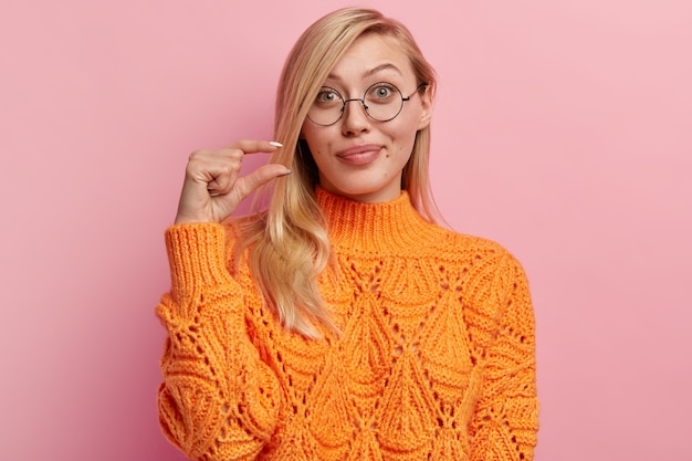 Joven rubia en suéter naranja