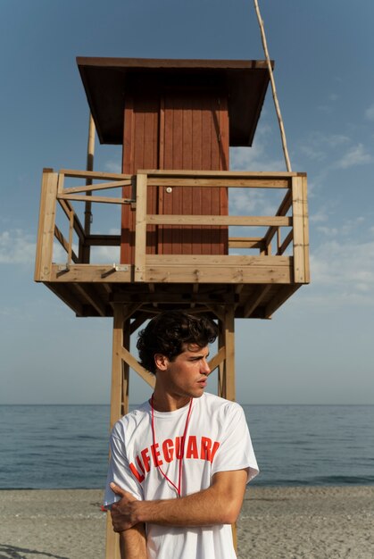 Joven salvavidas de tiro completo en la playa