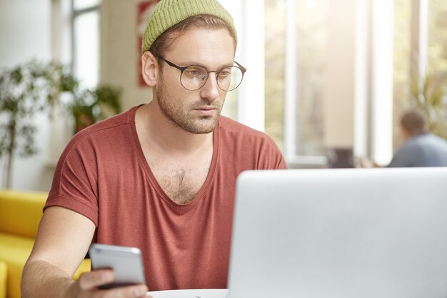 Joven, sentado, en, café, con, computador portatil