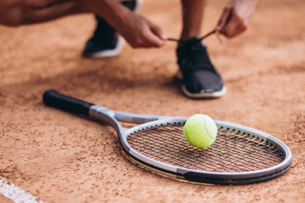 Joven tenista en la cancha, raqueta de tenis de cerca
