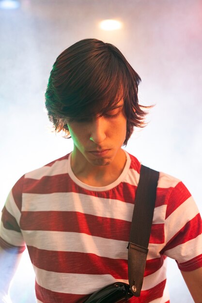 Joven tocando música de guitarra en un evento local