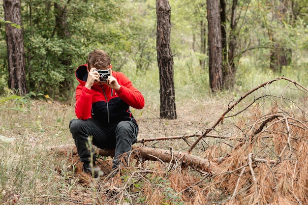 Foto gratuita joven tomando fotos en el bosque con espacio de copia