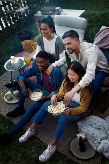 Jóvenes amigos divirtiéndose en el cine al aire libre