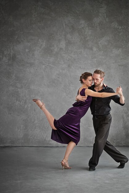 Jóvenes bailando tango en un estudio.