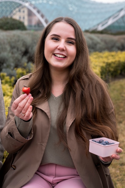 Foto gratuita jóvenes comiendo bayas en la calle