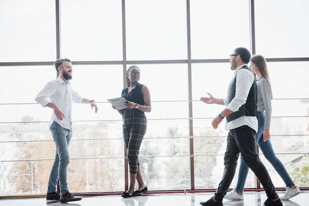 Jóvenes empresarios están discutiendo nuevas ideas creativas juntos durante una reunión en la oficina