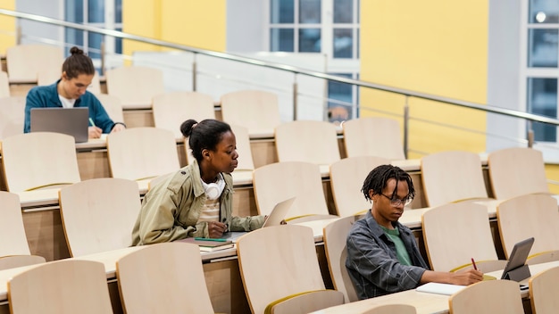 Jóvenes estudiantes que asisten a una clase universitaria.