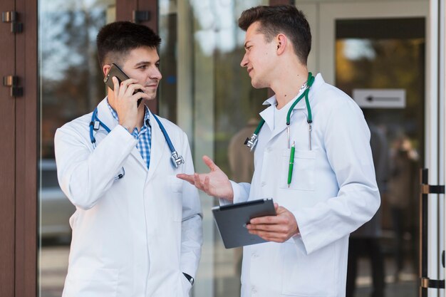 Jóvenes médicos hablando en la puerta