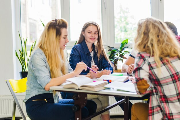 Jóvenes trabajando con libros de texto