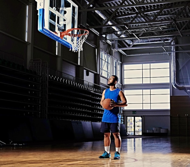 Foto gratuita jugador de baloncesto profesional negro en acción en un campo de baloncesto.