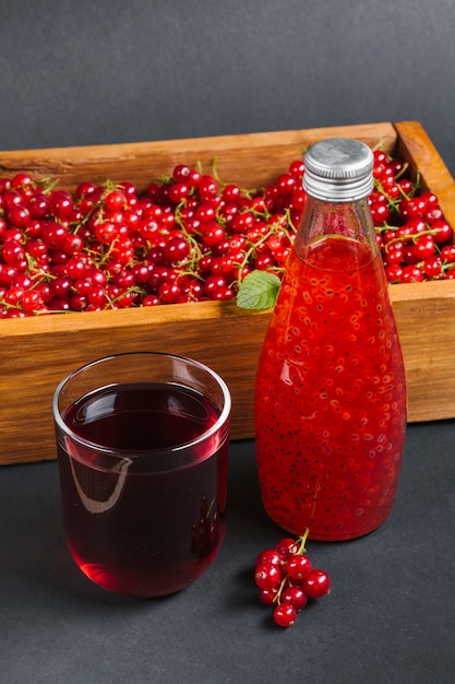 Foto gratuita jugo de arándanos y fruta en caja de madera.