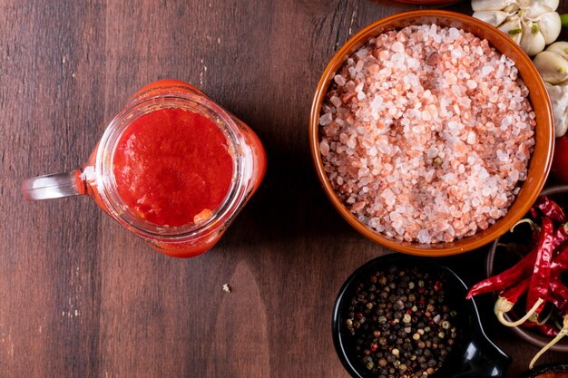 jugo de tomate con especias vista superior en mesa de madera