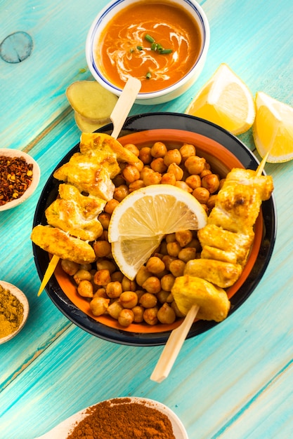 Foto gratuita kebab de garbanzo y pollo en medio de condimentos