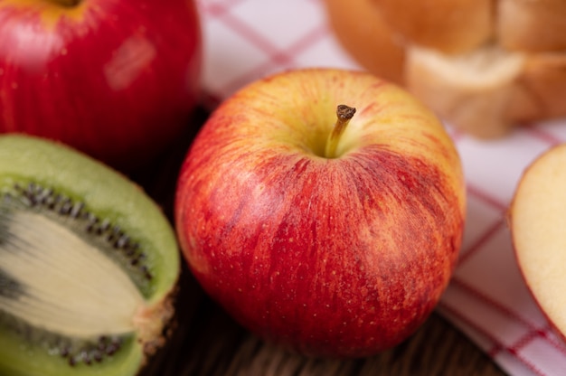 Kiwi, manzanas y pan en la mesa