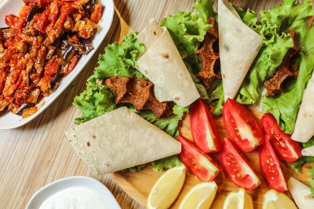 Kofte turco con tomate, limón, lavash y lechuga