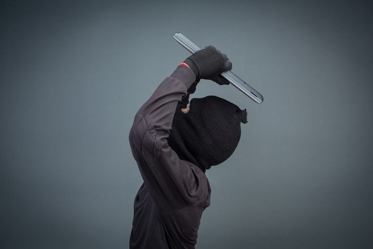 Foto gratuito los ladrones masculinos roban una computadora portátil en gris