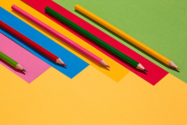 Lápices de colores y papel de color.