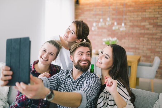 Laughing young people taking selfie