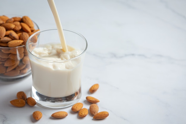 Leche de almendras con almendras sobre fondo de mármol