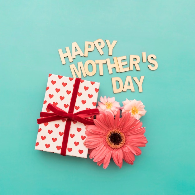 Lettering "happy mother's day", caja de regalos y flores de cerca