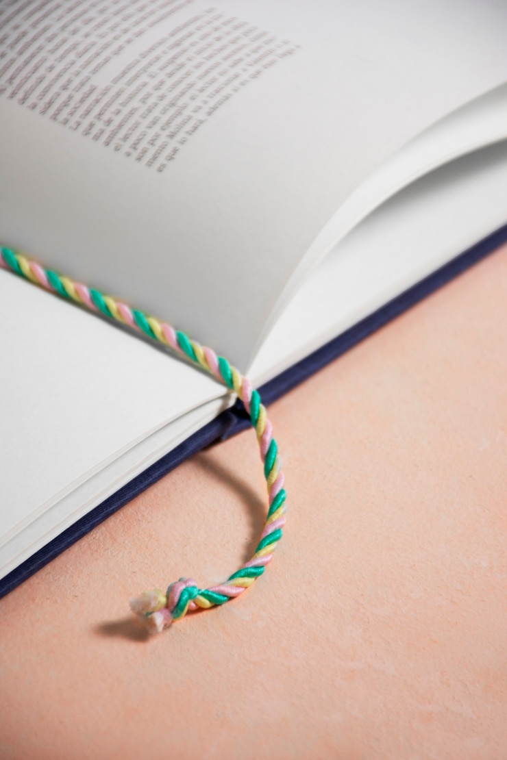 Foto gratuito libro de alto ángulo con marcador textil.