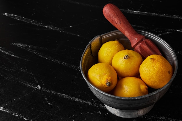 Limones aislados en una taza metálica.