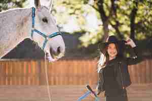 Foto gratuita linda chica con caballo blanco