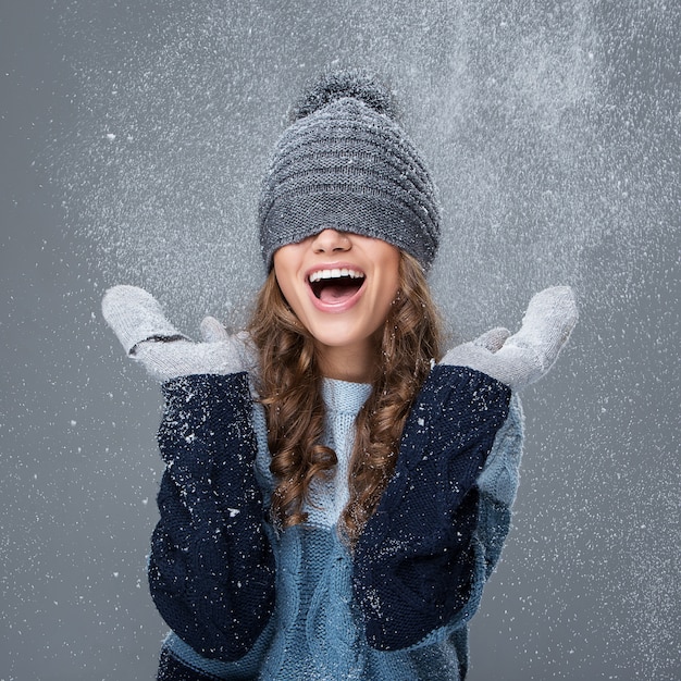 Linda chica con copos de nieve pasando un buen rato