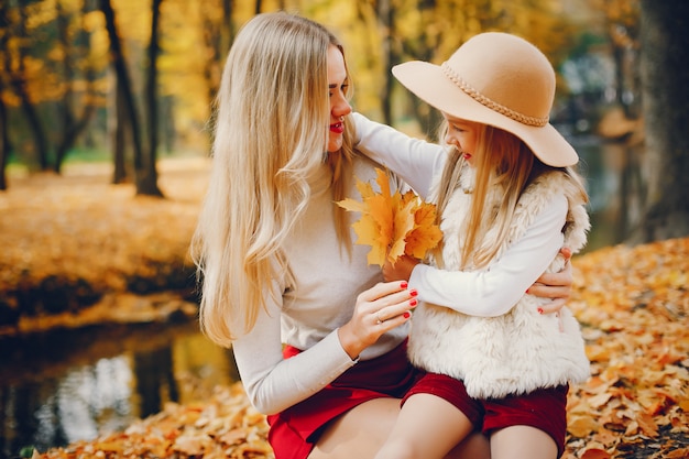 Linda y elegante familia en un parque de otoño