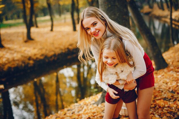 Linda y elegante familia en un parque de otoño