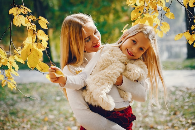 Linda y elegante familia en un parque de otoño