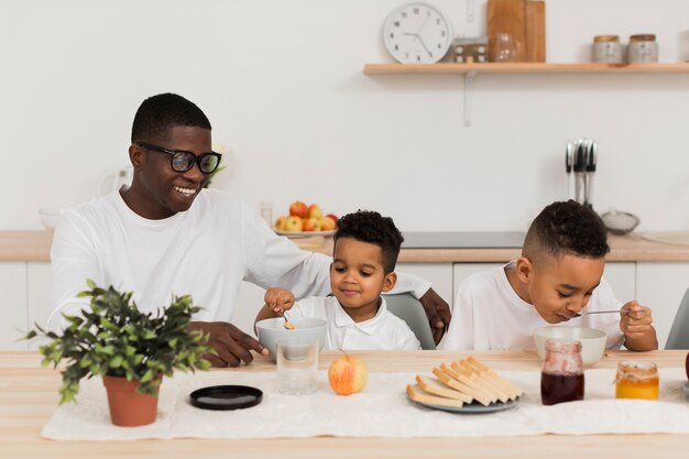 Linda familia comiendo juntos en la cocina