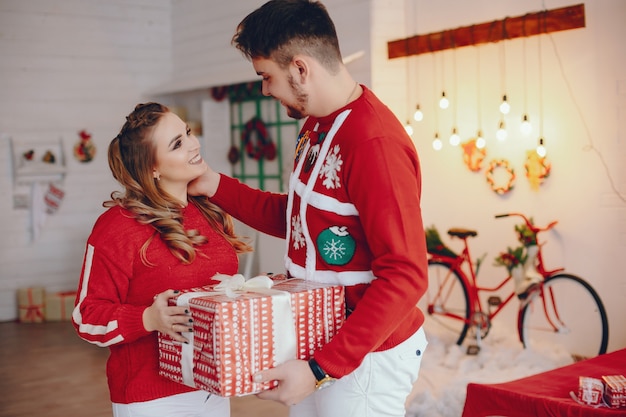 Linda familia de pie cerca del árbol de navidad