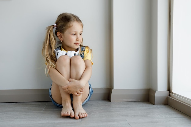 Foto gratuita linda niña en casa con auriculares