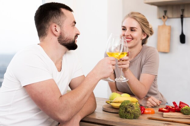 Linda pareja comiendo verduras y bebiendo juntos