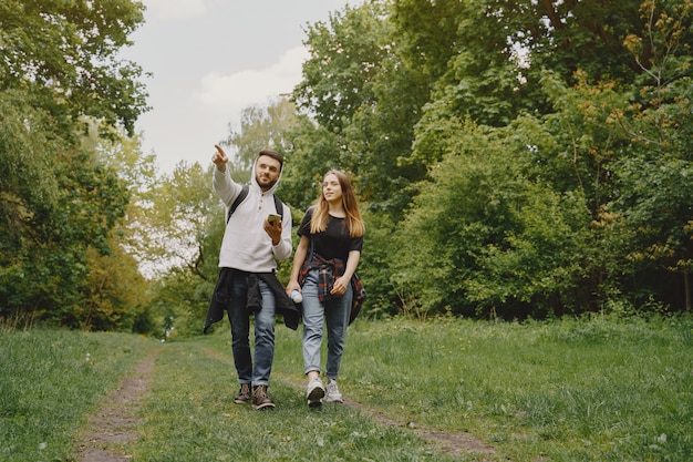 Linda pareja descansa en un bosque de verano