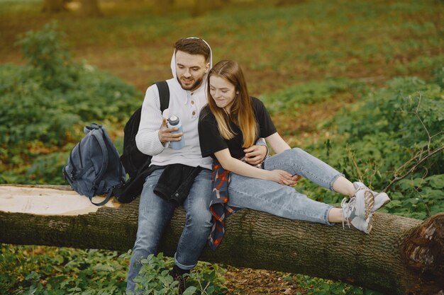 Linda pareja descansa en un bosque de verano