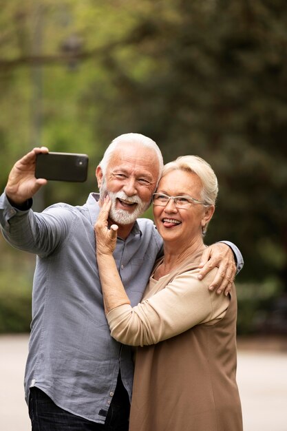 Linda pareja de tiro medio tomando selfie